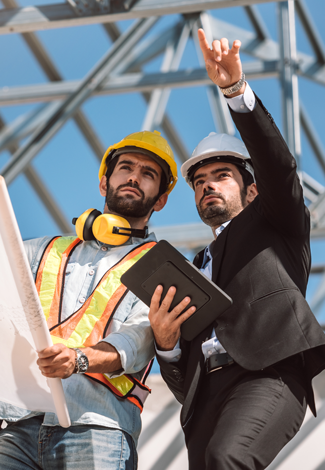 Two Engineers Discussing Plans at a Construction Site