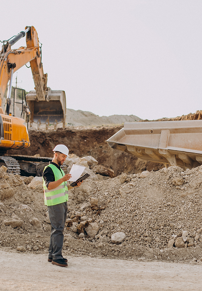 Construction Worker Overseeing Site Preparation for Building Construction