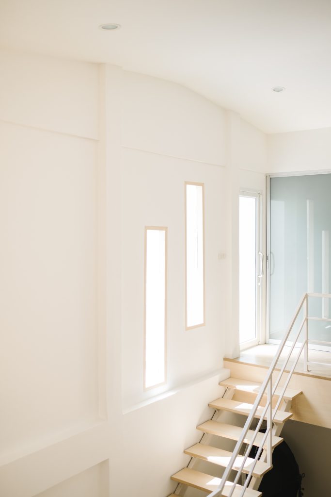 Minimalist Staircase with Bright Natural Light and White Walls